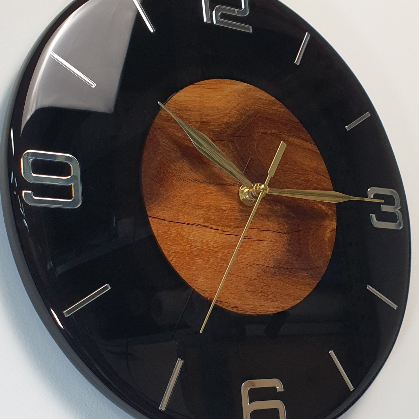 Close-up of the natural wood core and mirrored plexiglass numbers