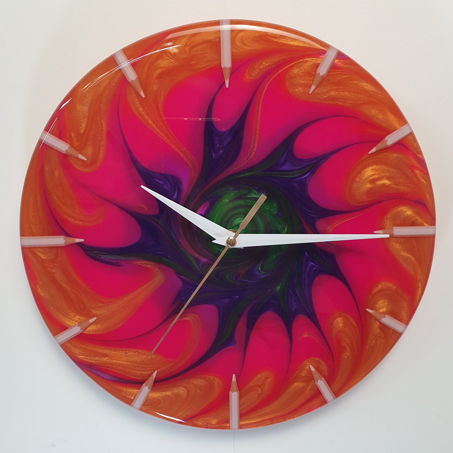 Front view of the “Neon Spiral” resin wall clock showing its vivid spiral pattern and glossy finish