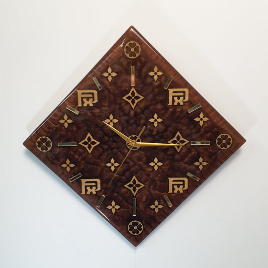 Front view of the FxPattern No.1 wall clock – handmade from resin and wood, featuring golden plexiglass markers and original geometric symbols.
