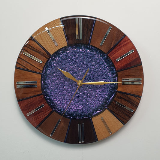 Front view of the “Cosmic Core” wall clock showing the chameleon resin center and natural wood segments