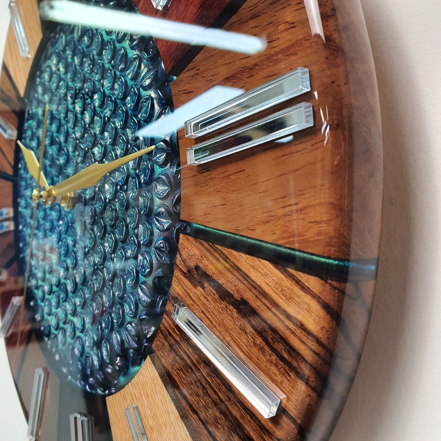 Close-up from the opposite side showing the mirrored plexiglass hour markers and gold hands