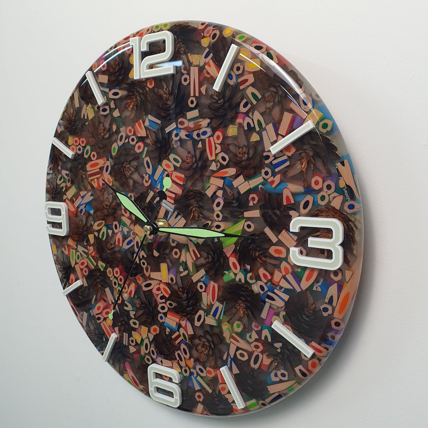 Macro detail of the resin surface revealing vivid colors, pinecone texture, and the depth of the epoxy finish.