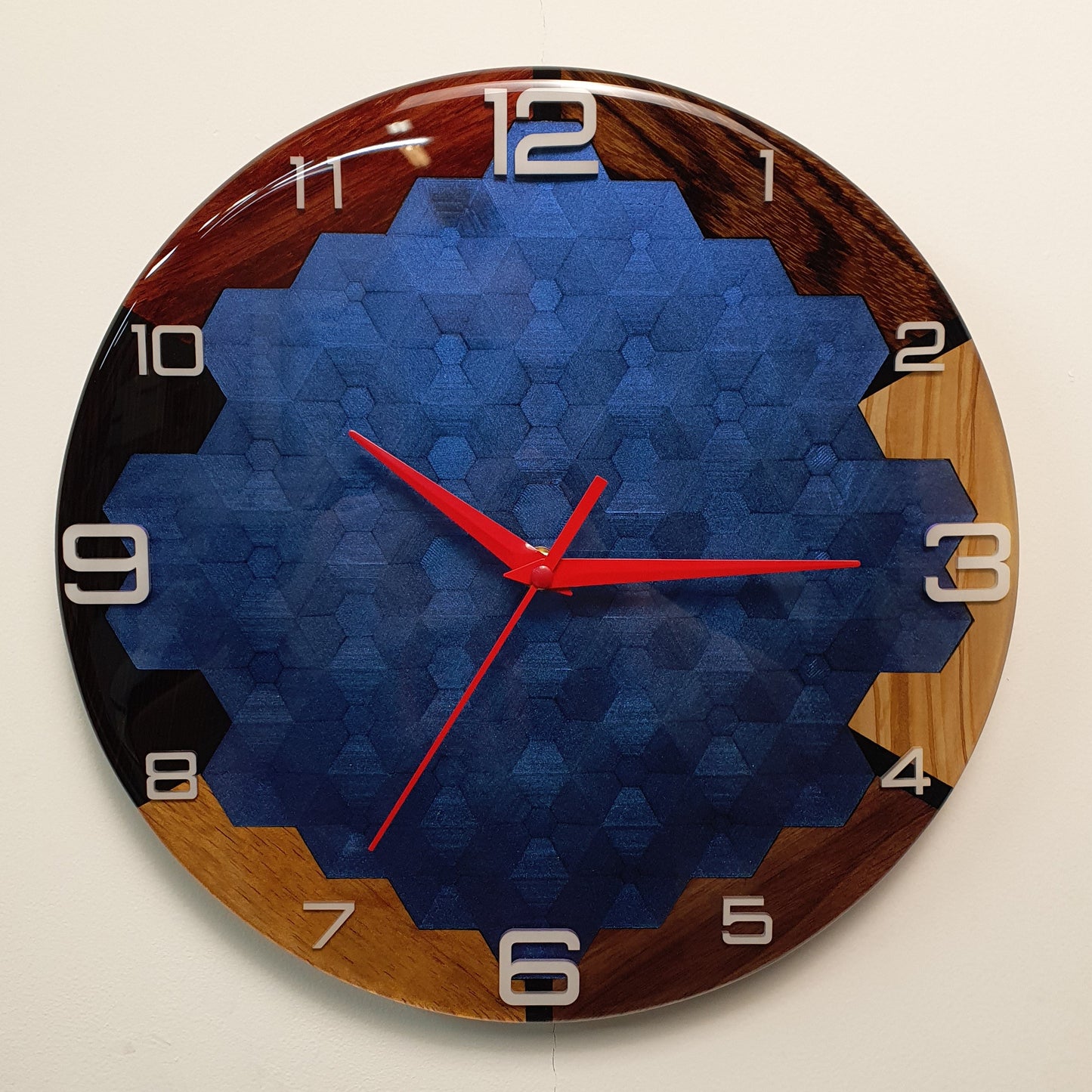 Front view of the Opal Geometry wall clock made from six woods and chameleon epoxy resin