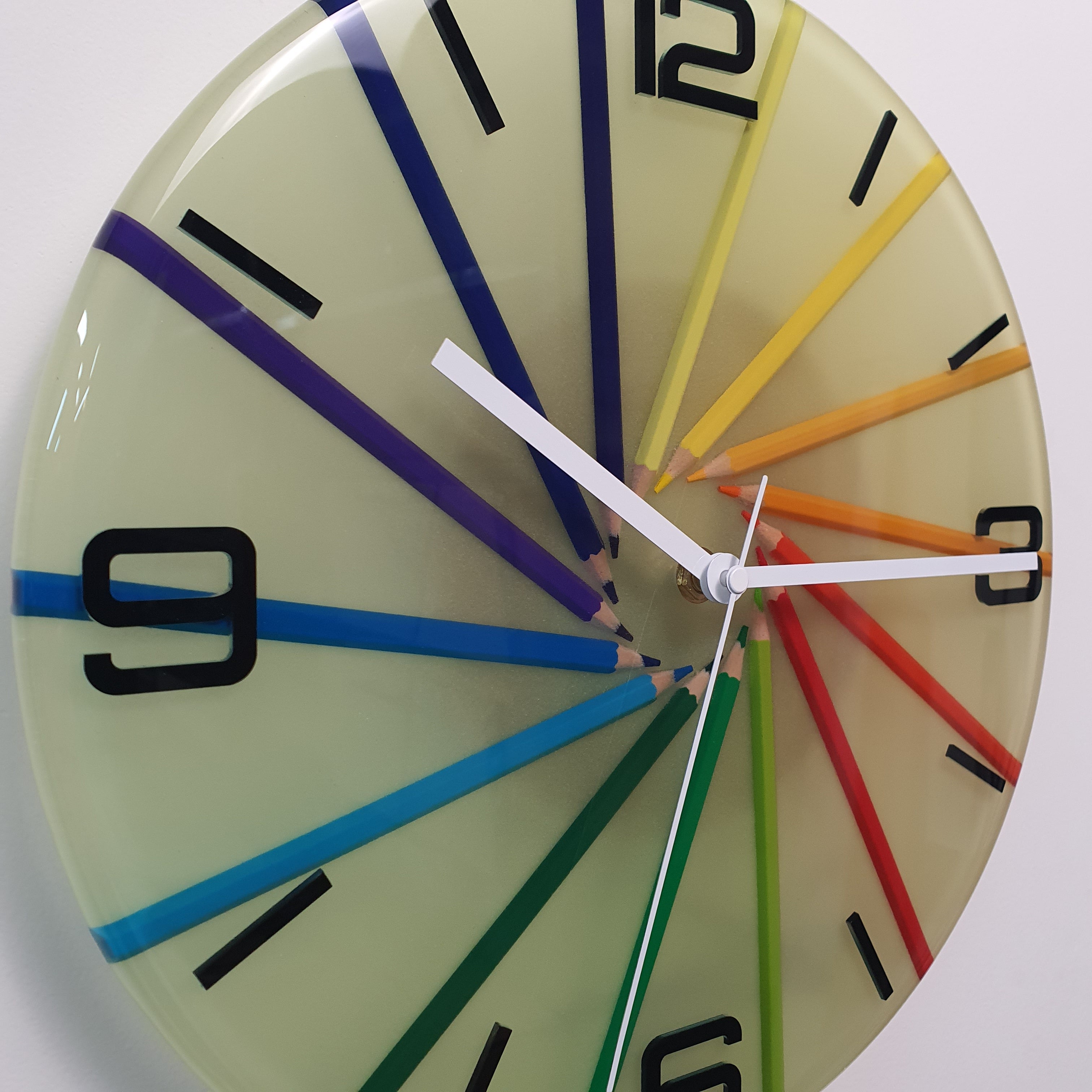 Close-up detail of Neon Spiral resin clock showing coloured pencils embedded in clear epoxy