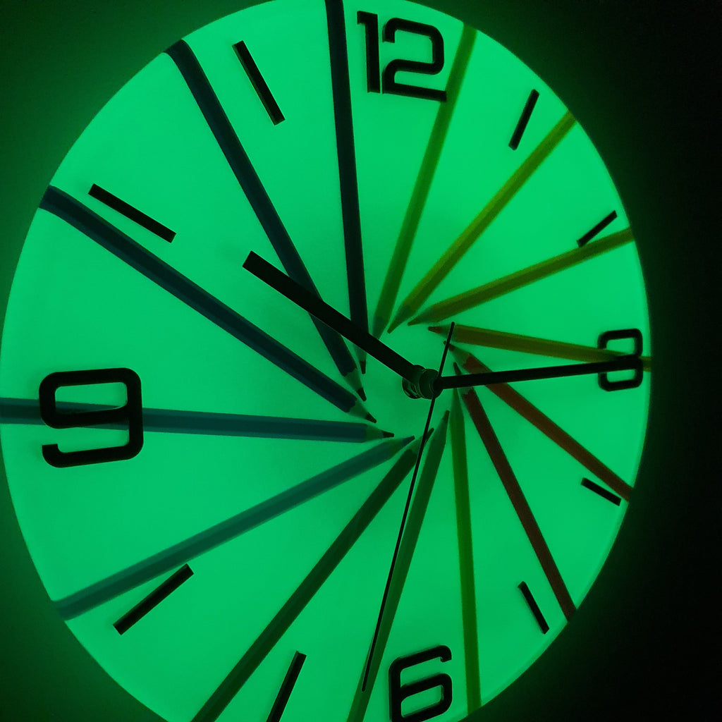 Close-up night detail of Neon Spiral clock illuminated with green glow