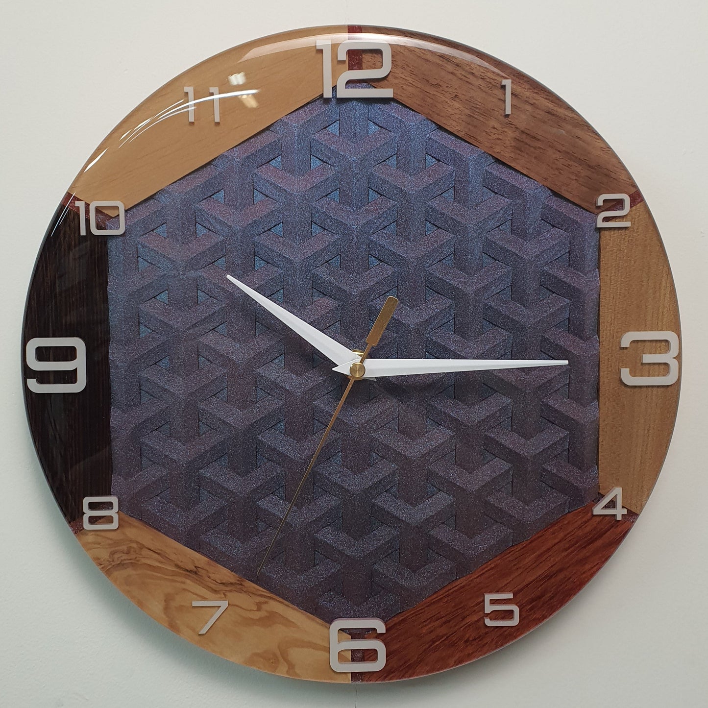 Wooden wall clock with iridescent 3D geometric pattern in center