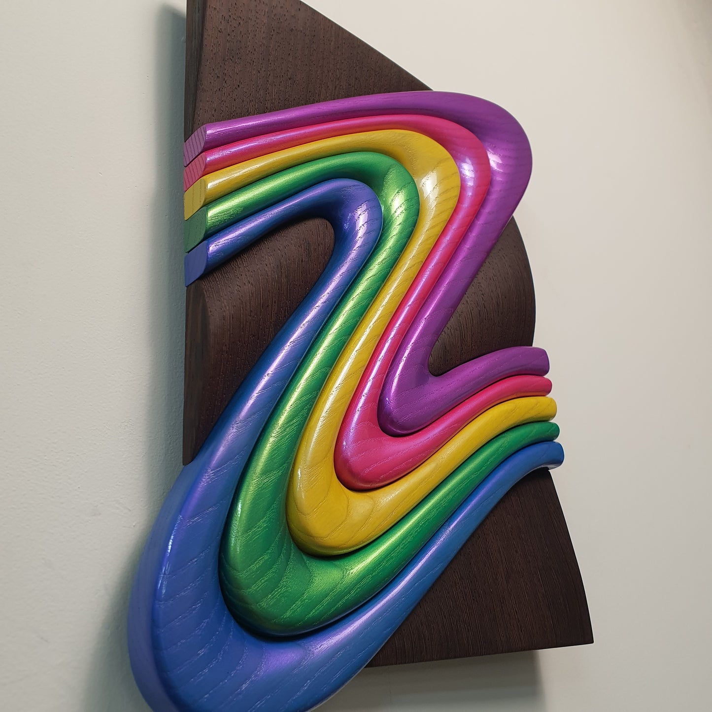 Z Frozen Motion wood sculpture detail showing color transitions and carving