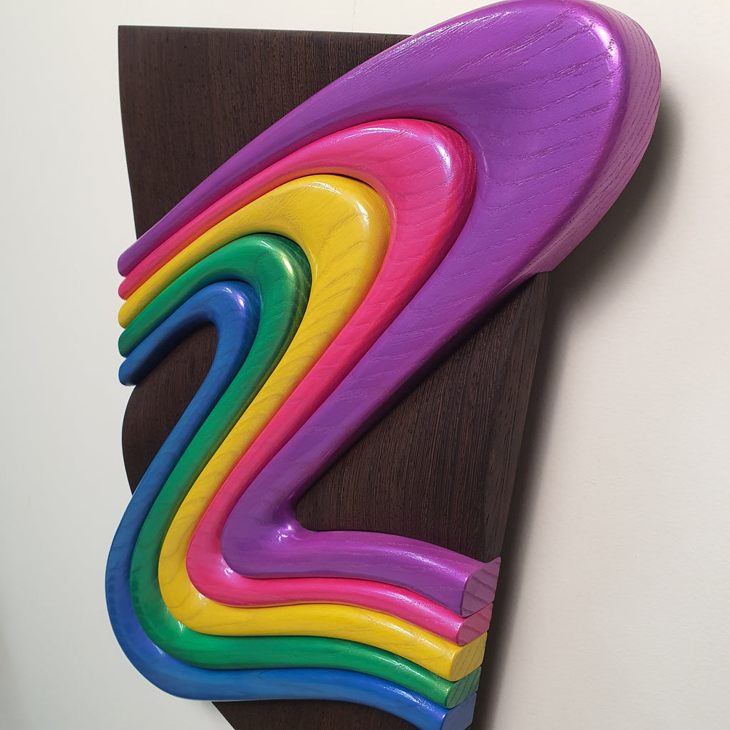 Z Frozen Motion side angle showing sculptural depth against dark wenge wood