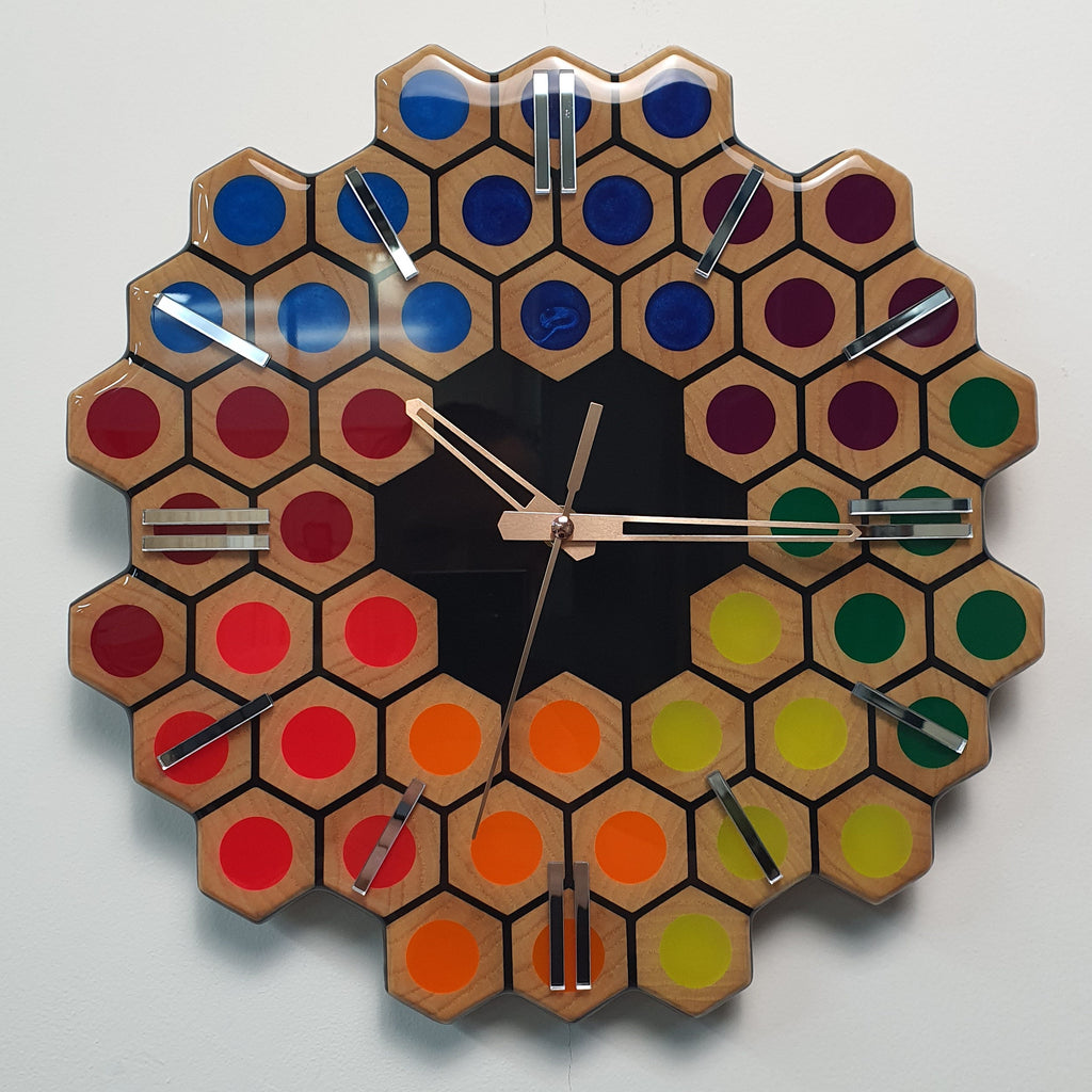 Spectrum Hive wooden wall clock with rainbow resin details and mirrored plexiglass markers front view