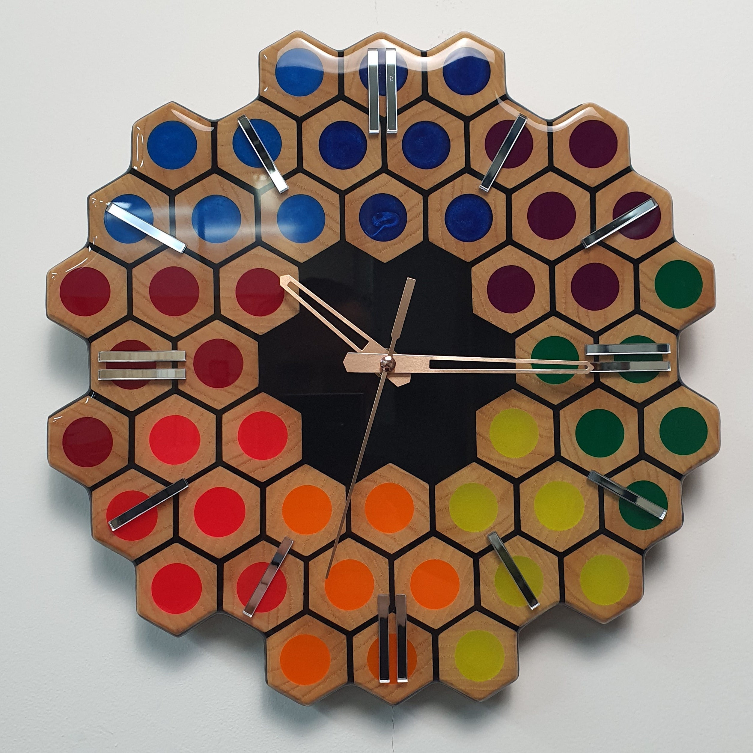 Spectrum Hive wooden wall clock with rainbow resin details and mirrored plexiglass markers front view