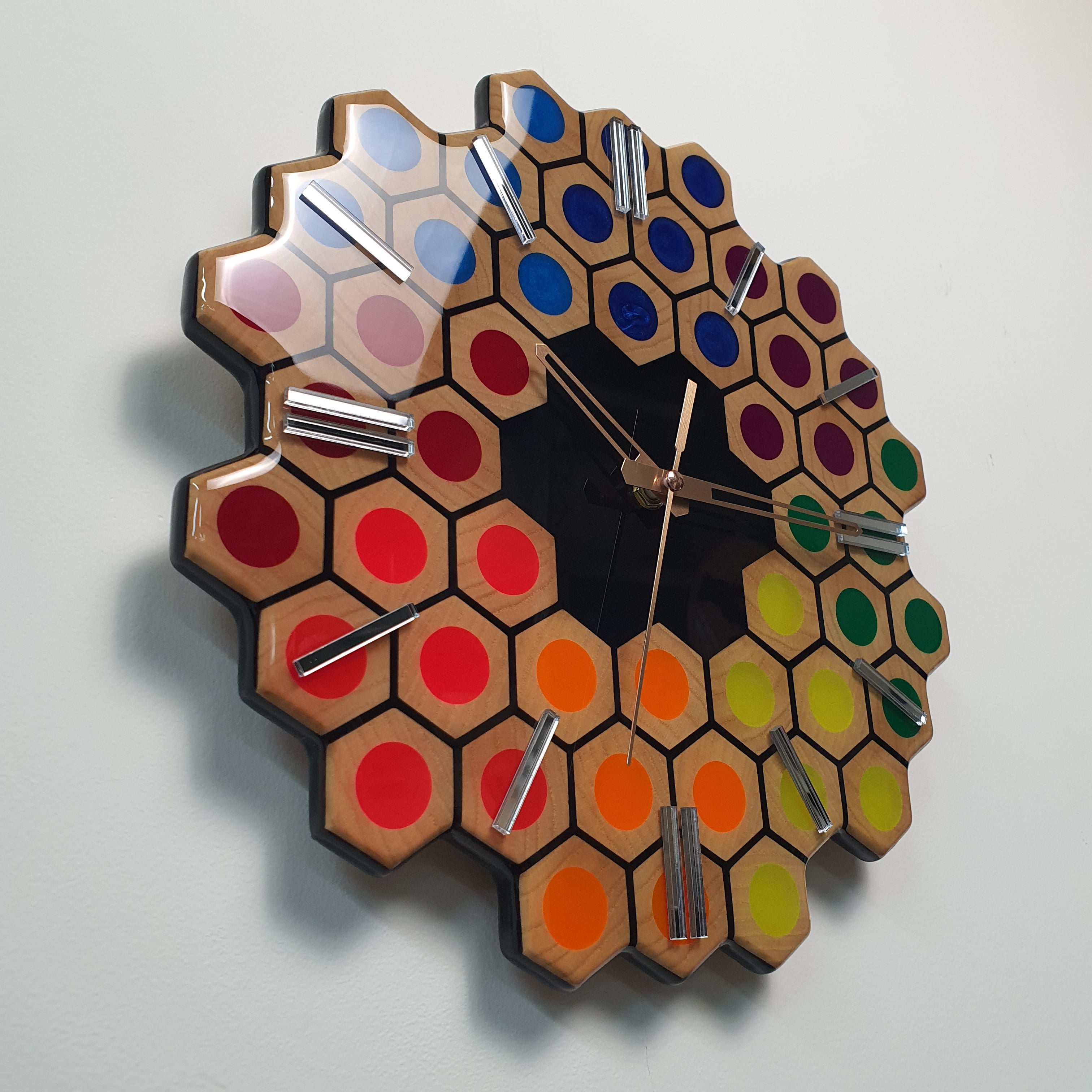 Detailed close-up of colorful resin and ash wood structure on Spectrum Hive clock