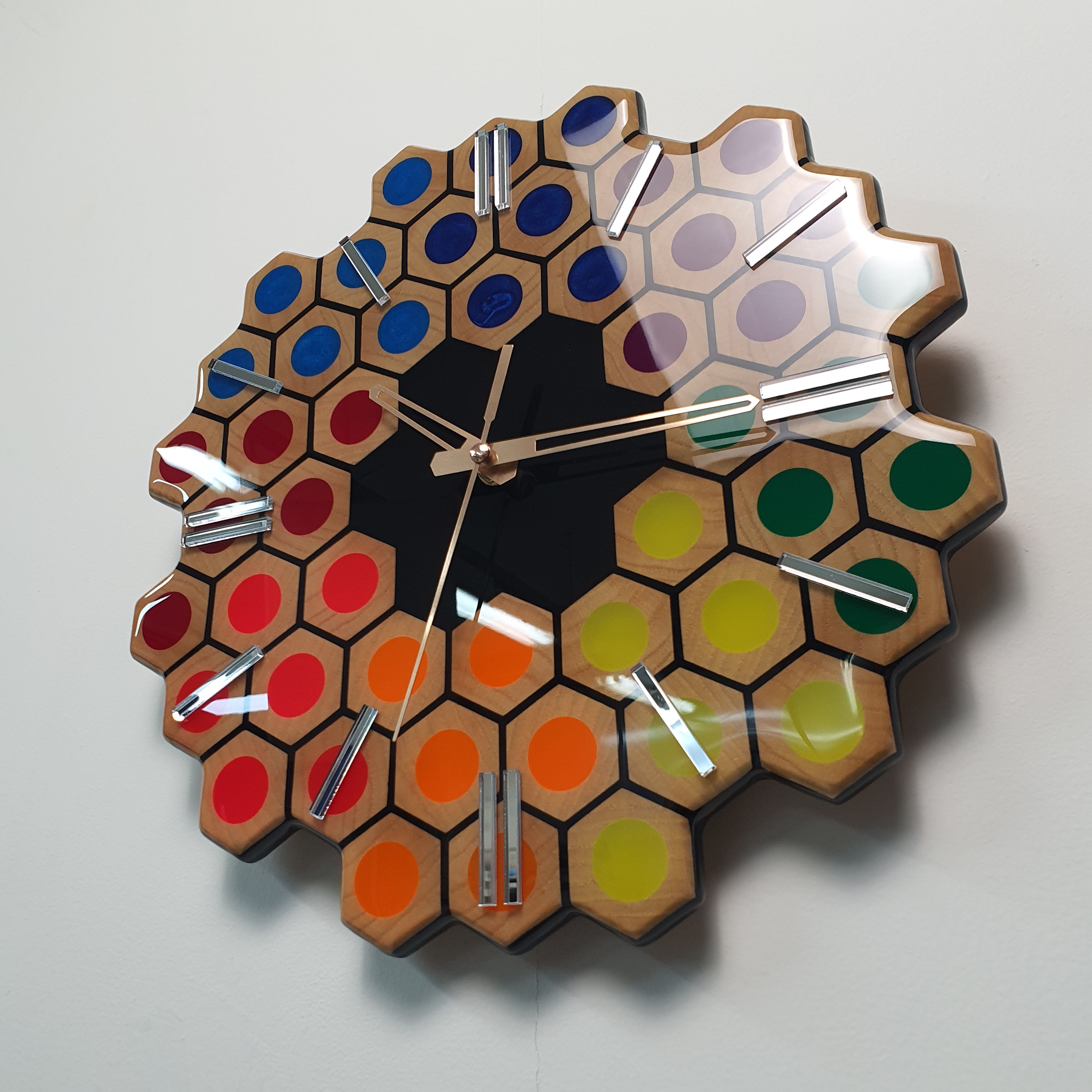 Side angle view of Spectrum Hive modern geometric wall clock with mirrored details