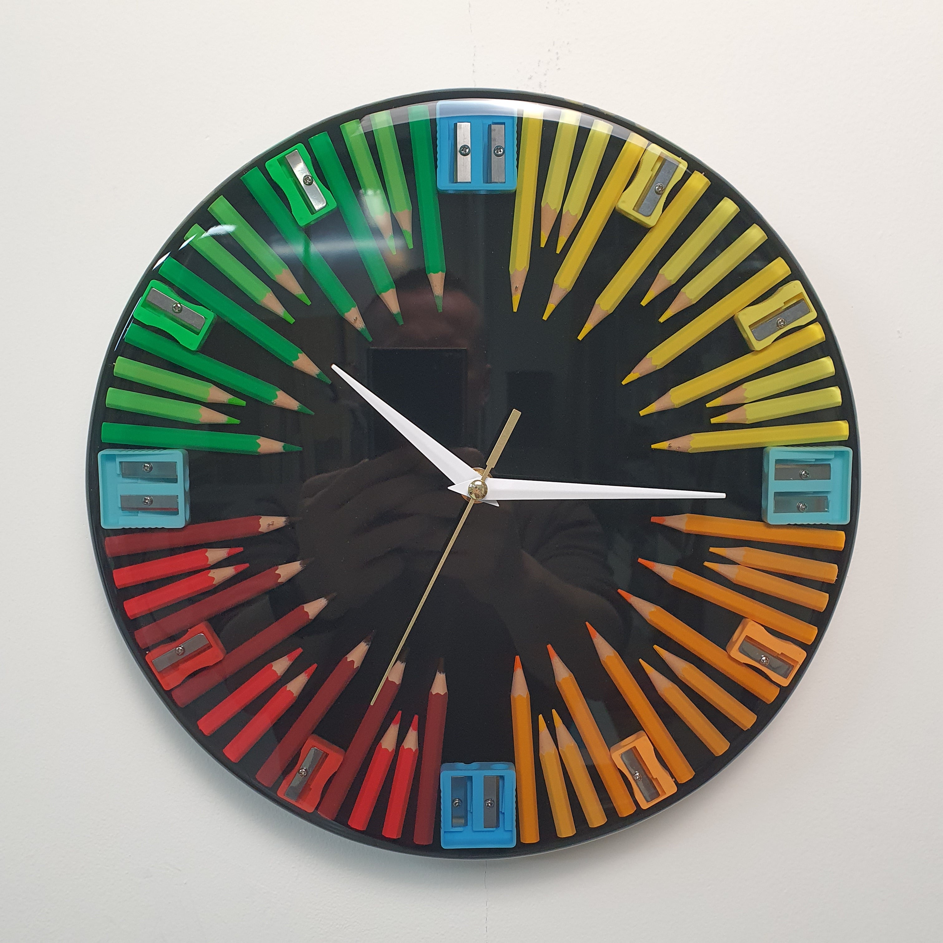 Creative Spin wall clock made with colored pencils and sharpeners front view