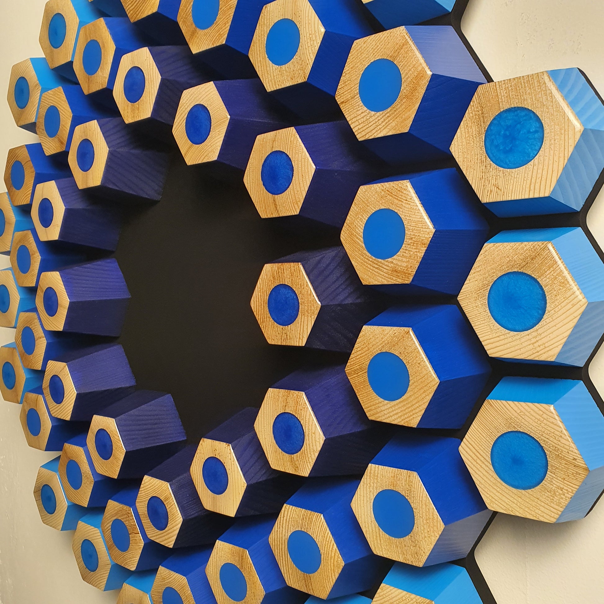 Handmade 3D wooden wall art with hexagonal structure, glossy resin details and deep black center