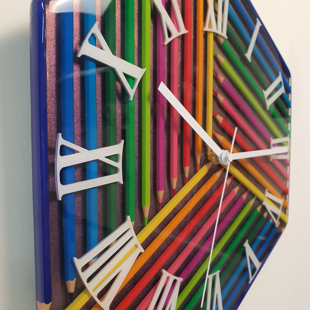 Close-up of colorful pencil clock with shimmering chameleon background and epoxy coating