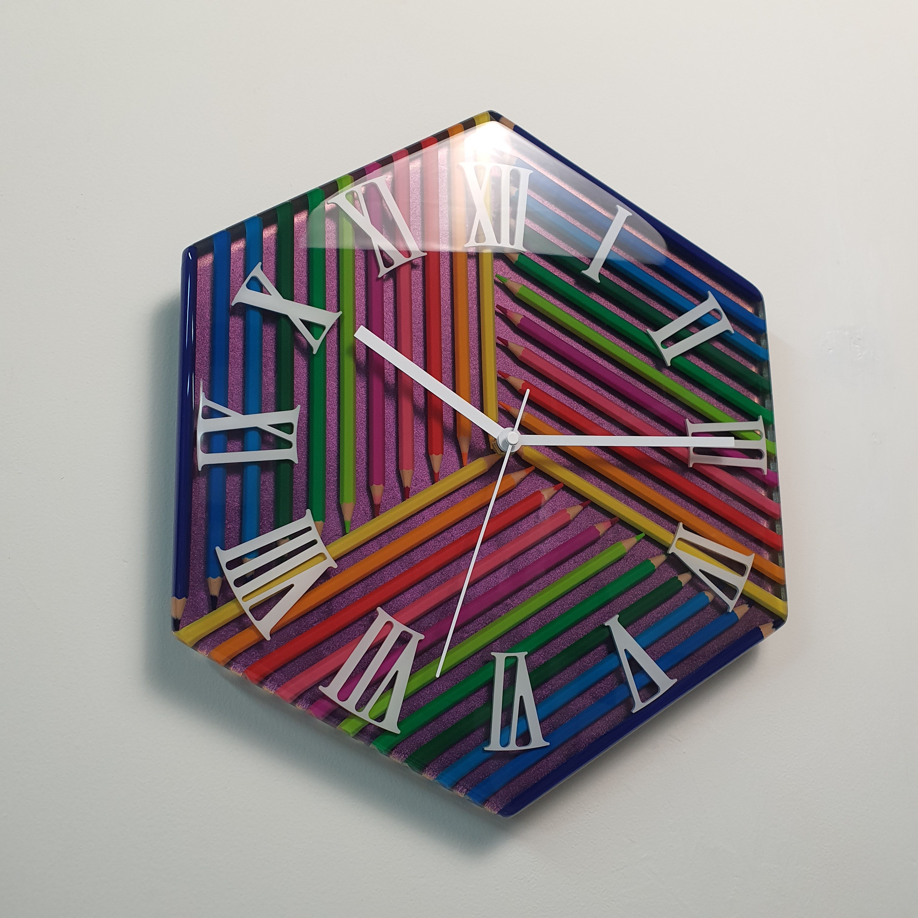 Artistic geometric wall clock made with colored pencils and white Roman numeral markers