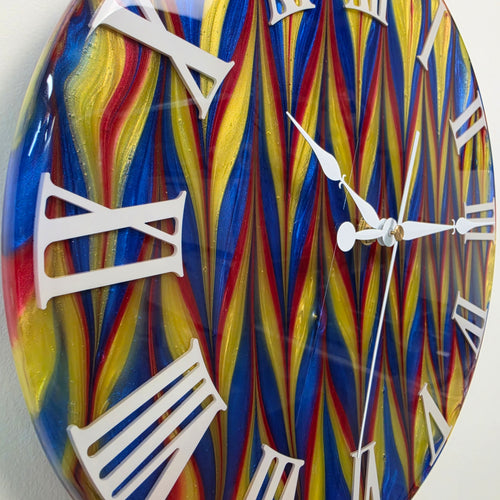 Close-up of Abstract Time clock showing intricate resin color movement and white plexiglass numerals