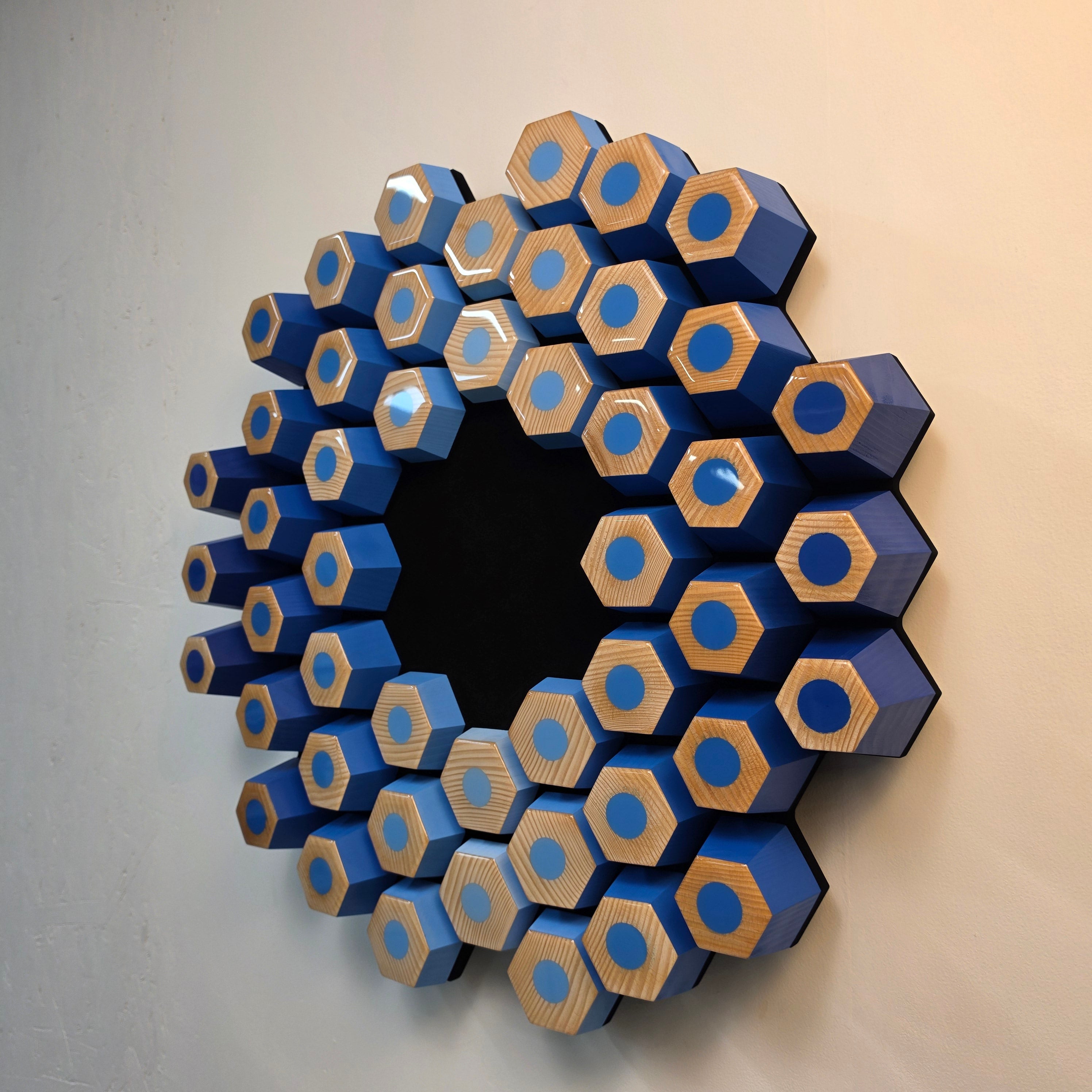 Handmade contemporary wall sculpture featuring angled wooden hexagons and resin details