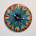Color Storm resin wall clock featuring swirling red, yellow and blue abstract patterns