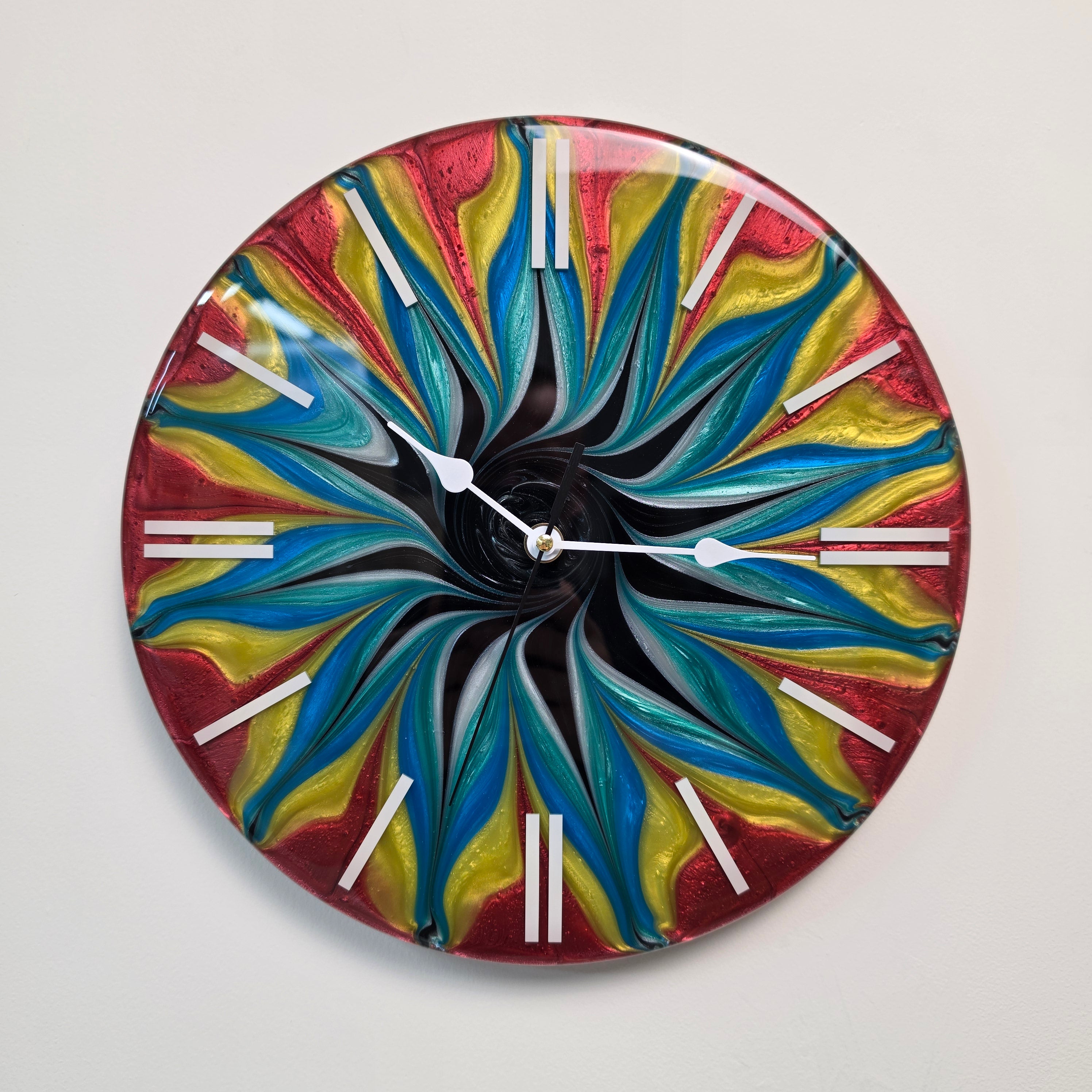 Color Storm resin wall clock featuring swirling red, yellow and blue abstract patterns