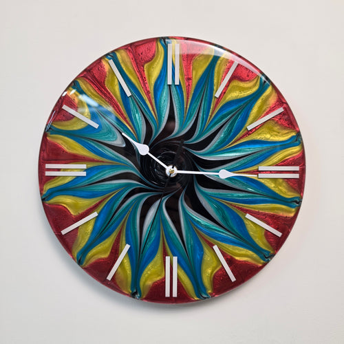 Color Storm resin wall clock featuring swirling red, yellow and blue abstract patterns