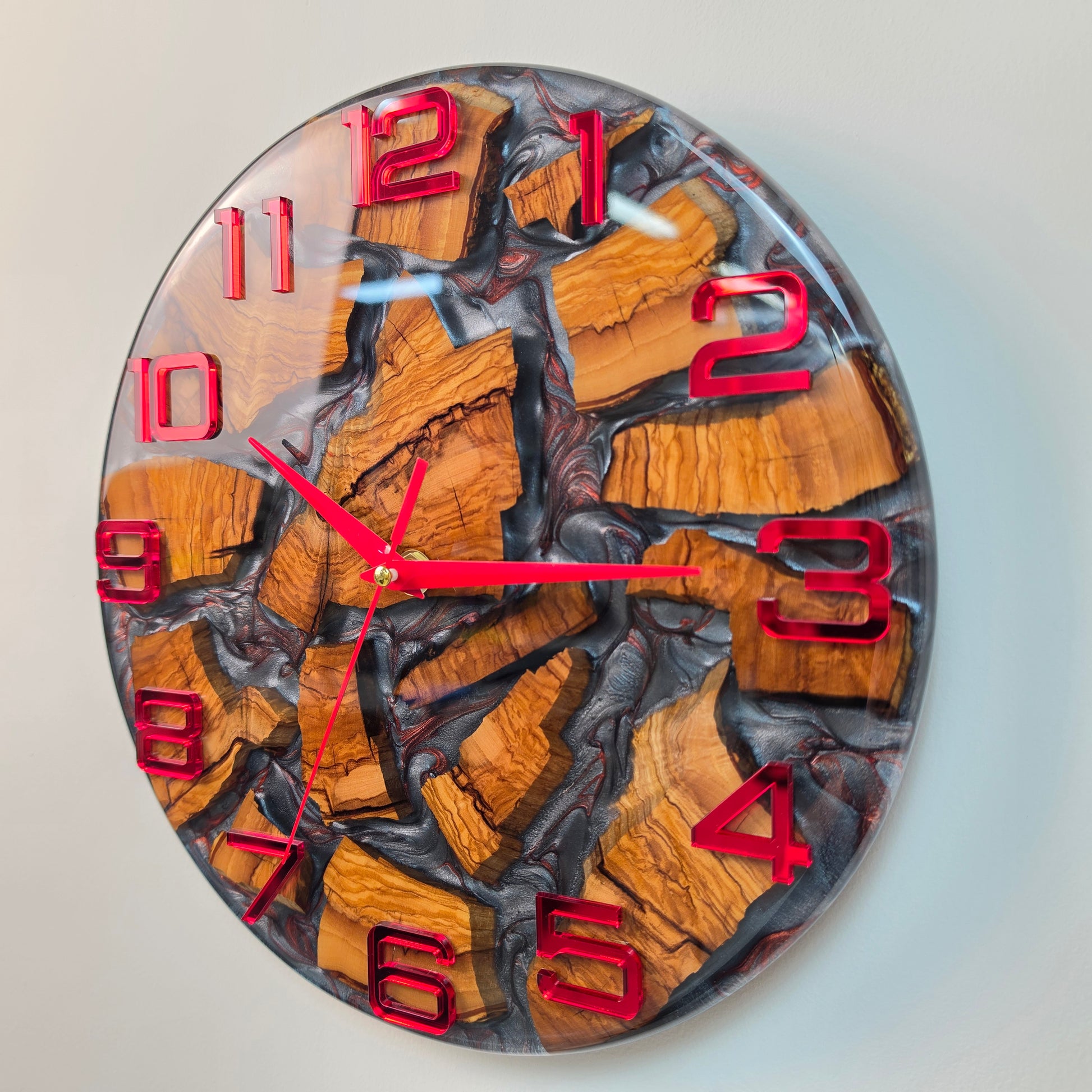 Modern resin and olive wood clock with natural grain and red accents