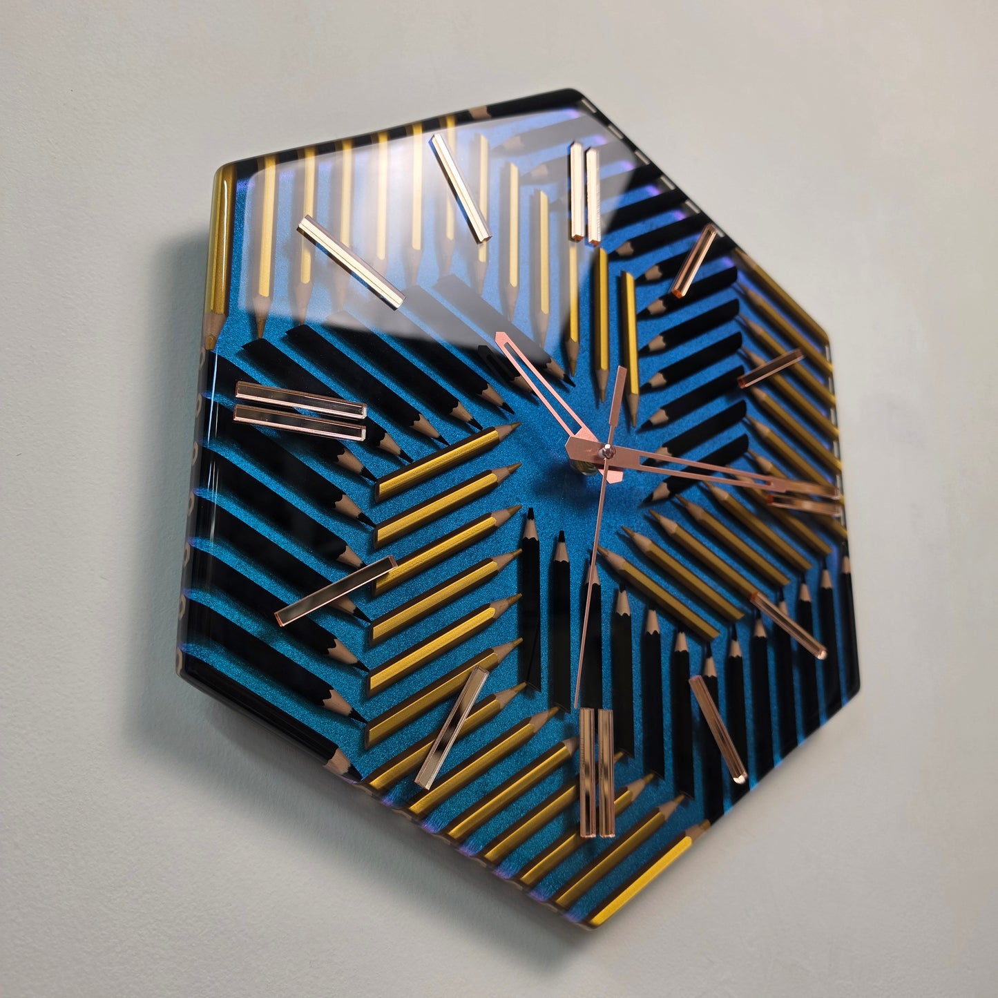 Geometry of Color wall clock made from black and gold colored pencils on a blue-violet chameleon background