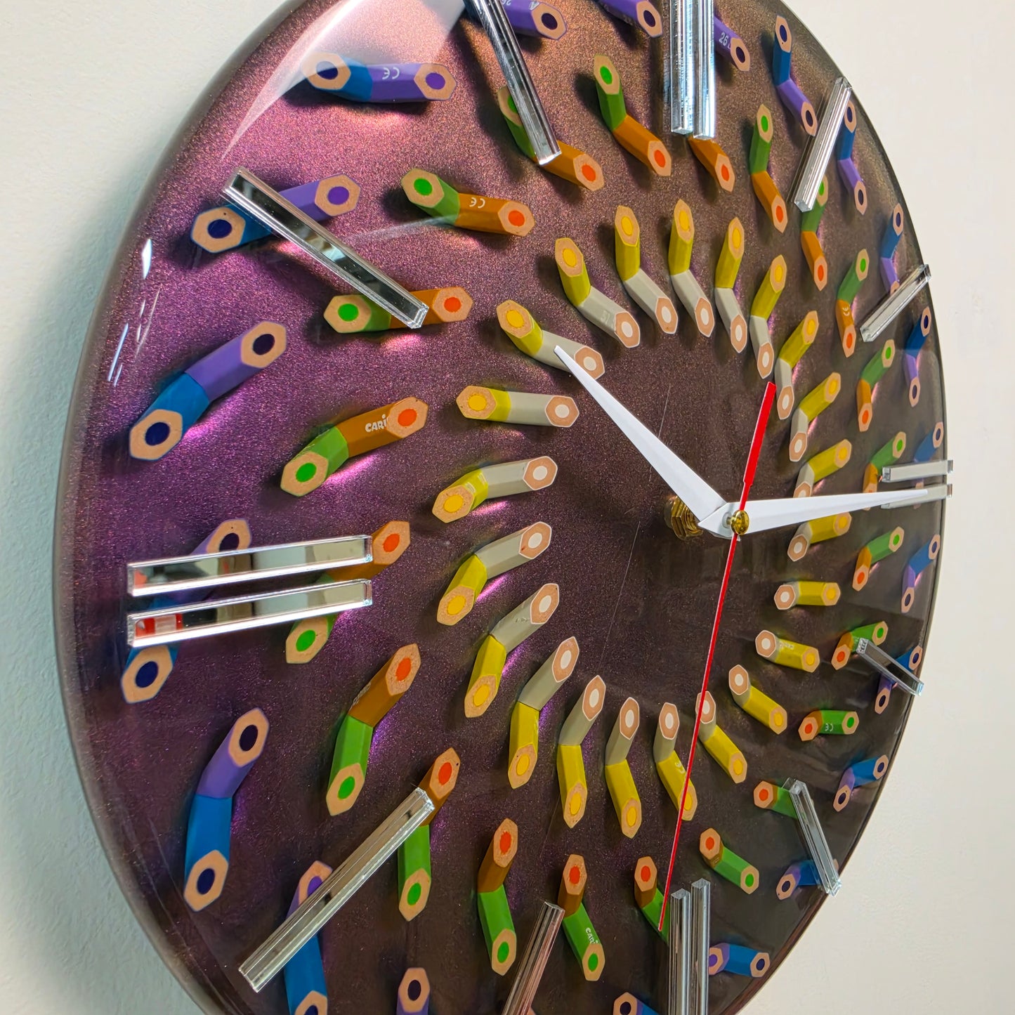 Handcrafted epoxy resin clock featuring 45-degree cut colored pencils