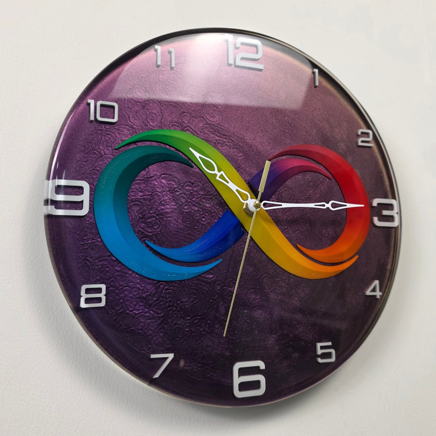 Endless Rhythm wall clock with a colorful infinity symbol on a purple chameleon resin background