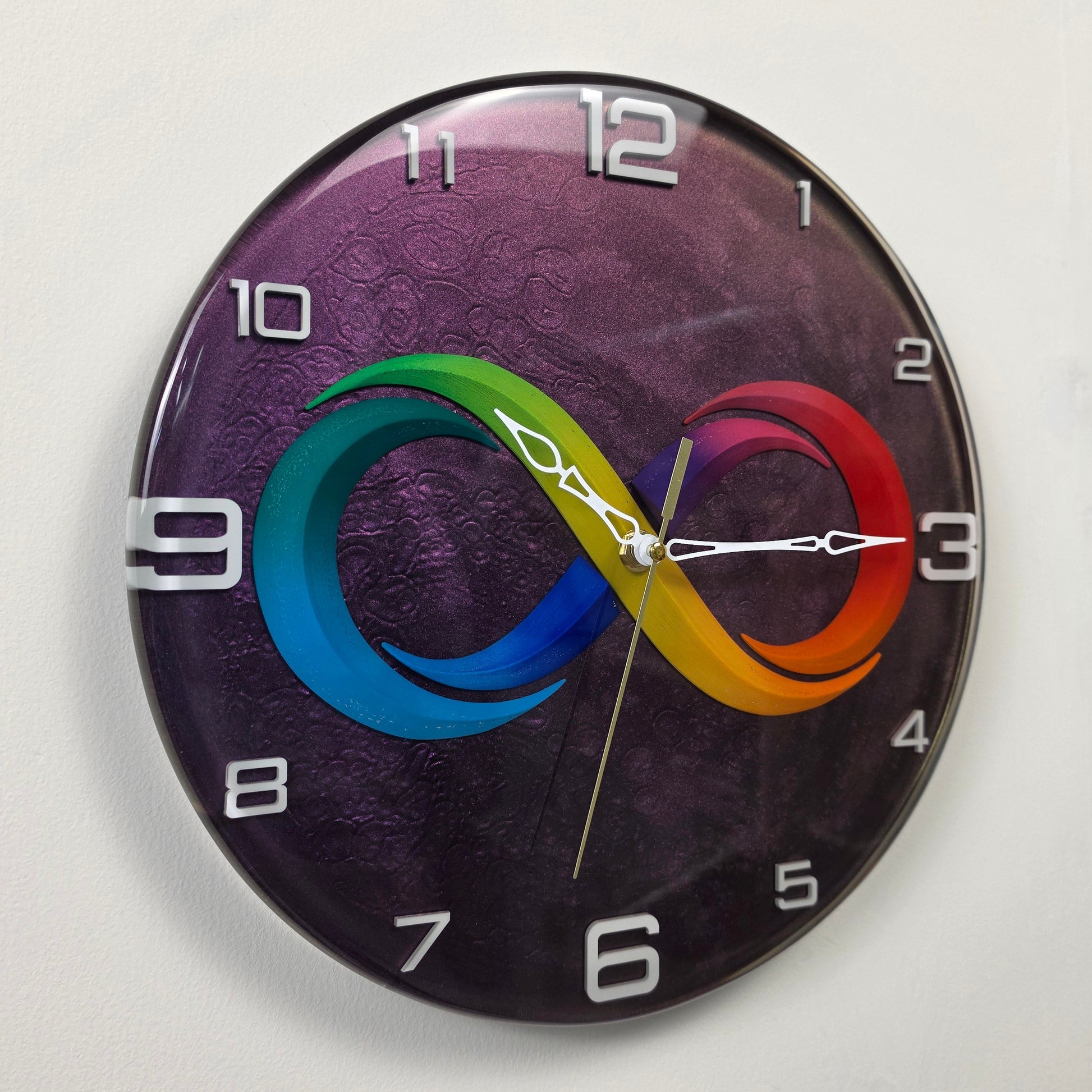 Contemporary handmade wall clock with infinity-inspired centerpiece and metallic purple background