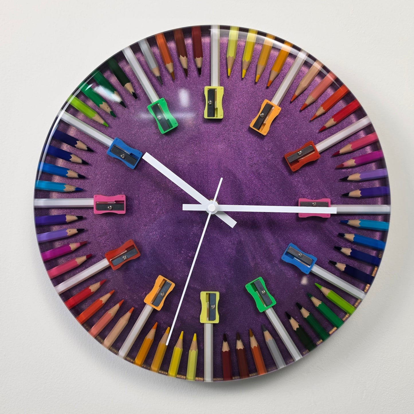Contemporary handmade resin wall clock with colored pencils and vibrant geometric design