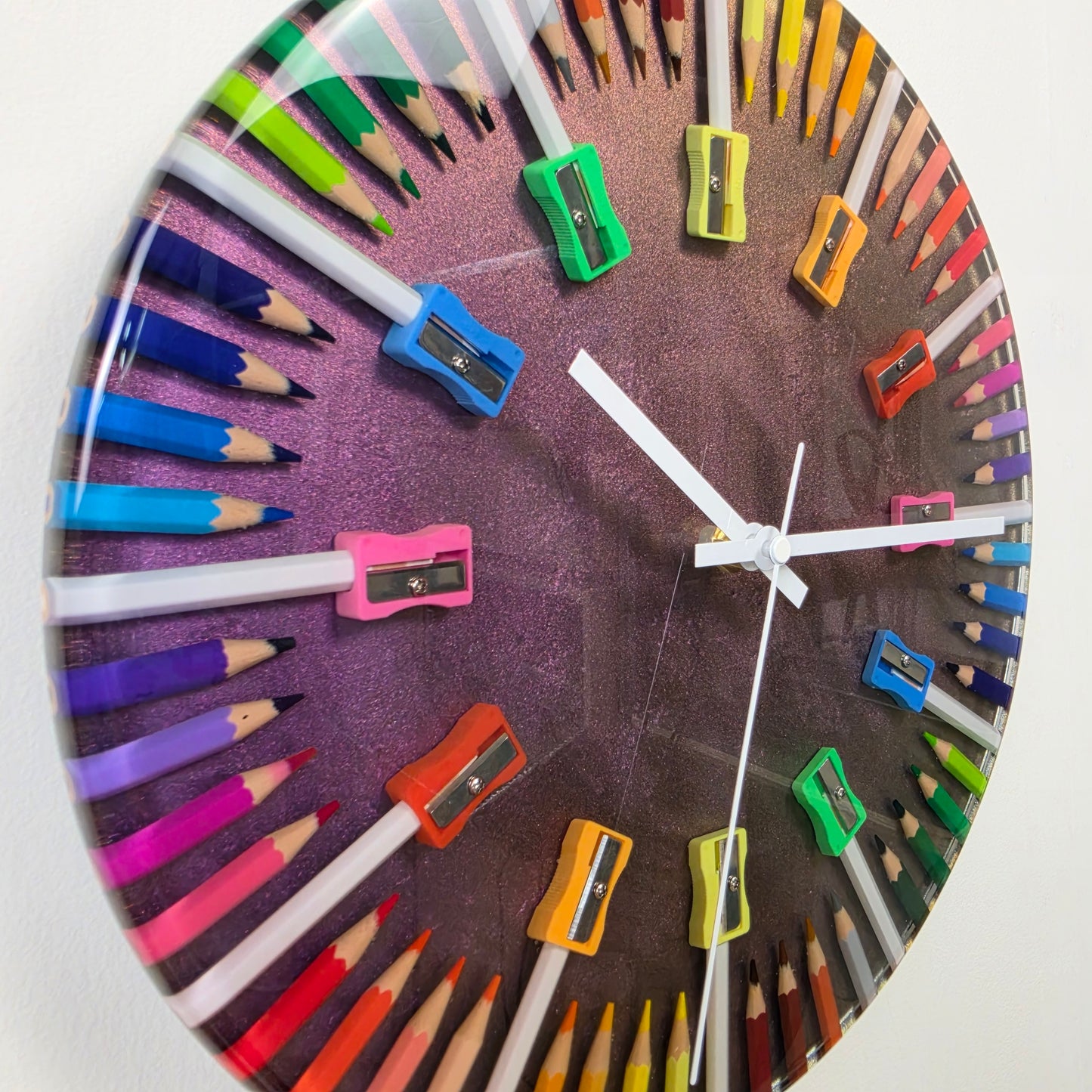 Handcrafted epoxy resin wall clock with colored pencils and chameleon-effect background