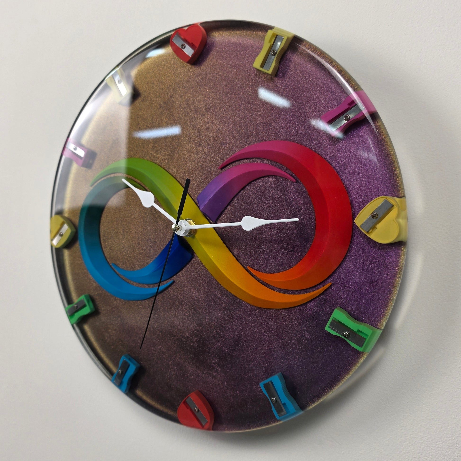 Modern handmade wall clock with infinity symbol, heart-shaped sharpeners and shimmering epoxy resin background