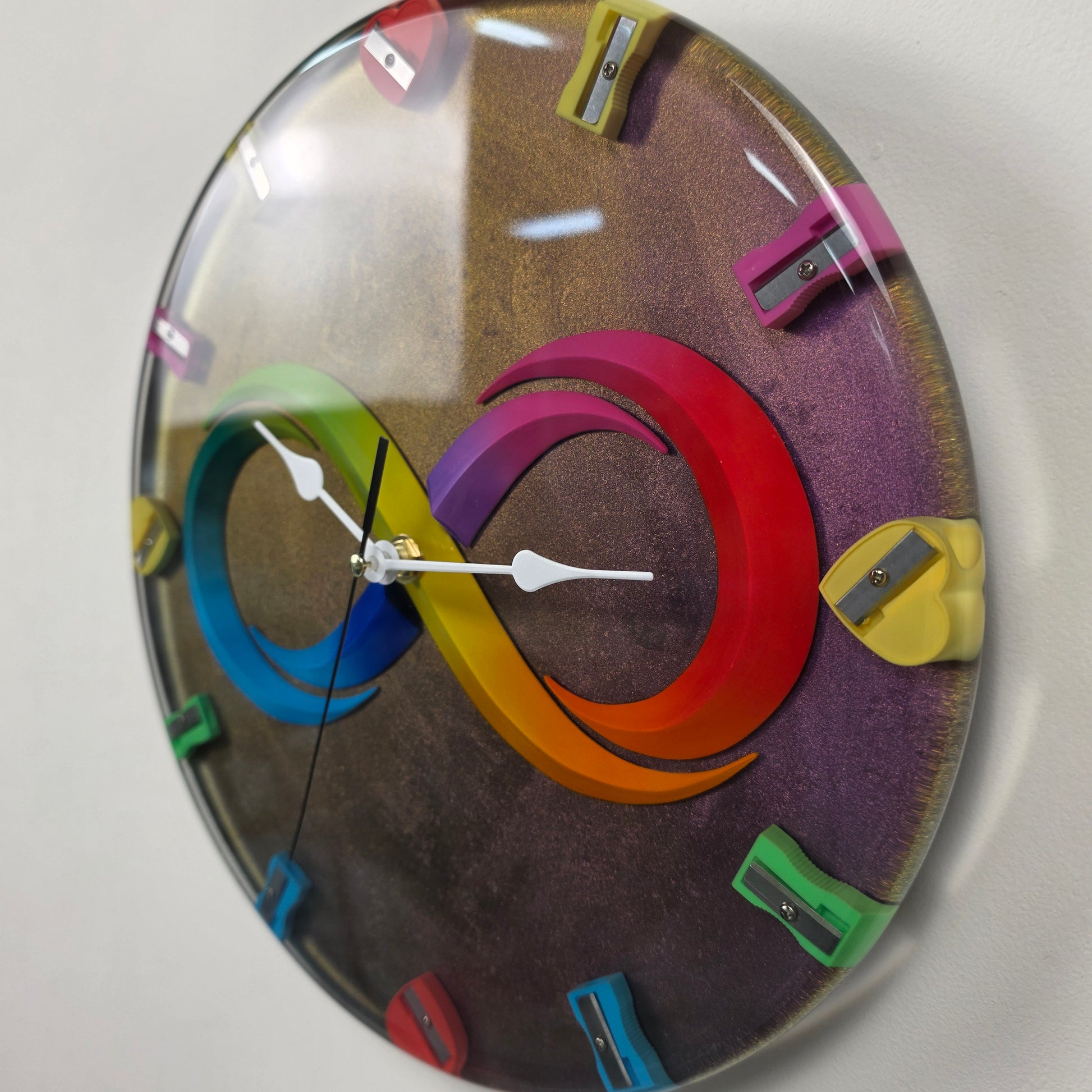 Artistic handmade wall clock from the Timeless Symbols collection with infinity symbol and creative pencil sharpeners