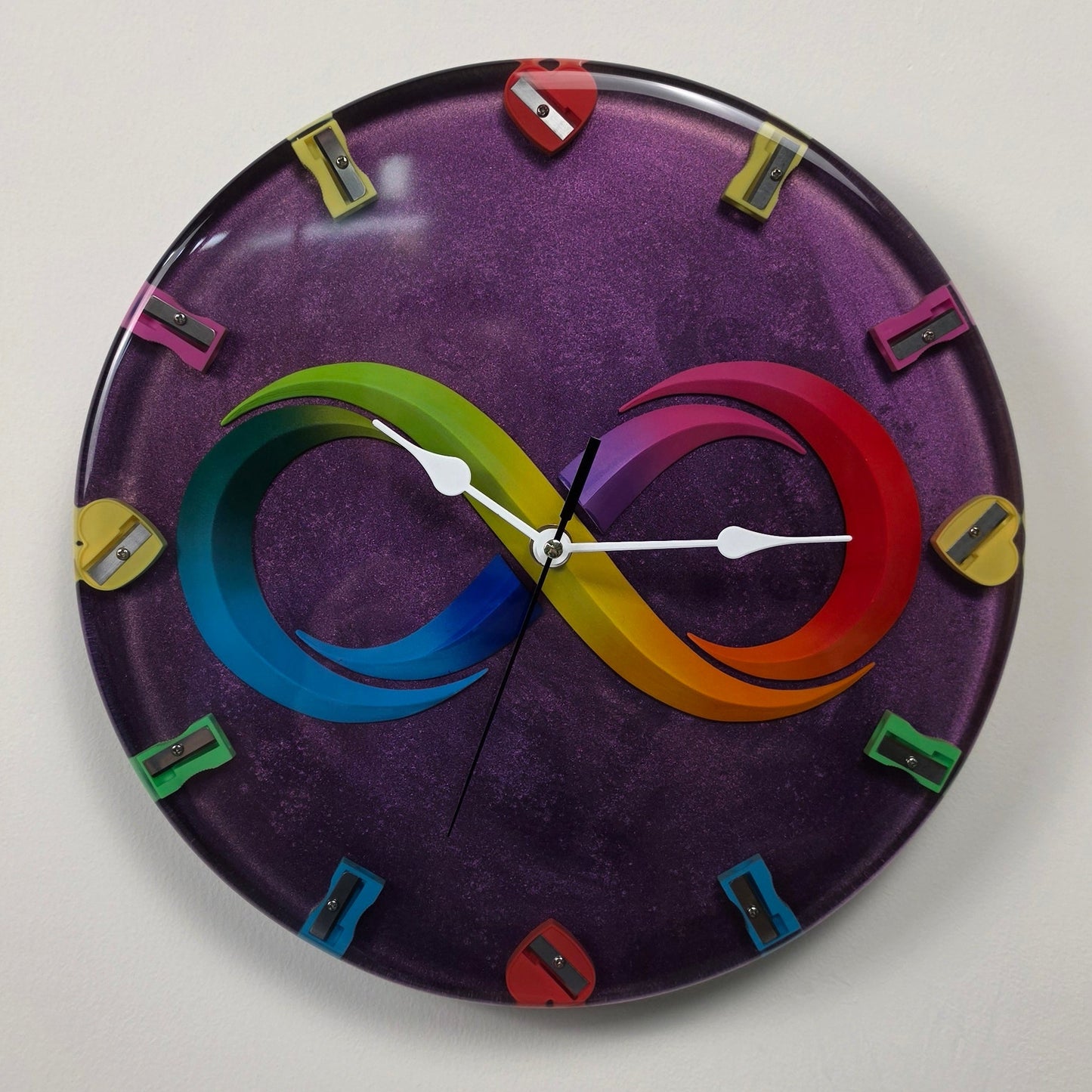 Luxury epoxy resin wall clock inspired by infinite creativity with artistic infinity symbol and colorful sharpeners