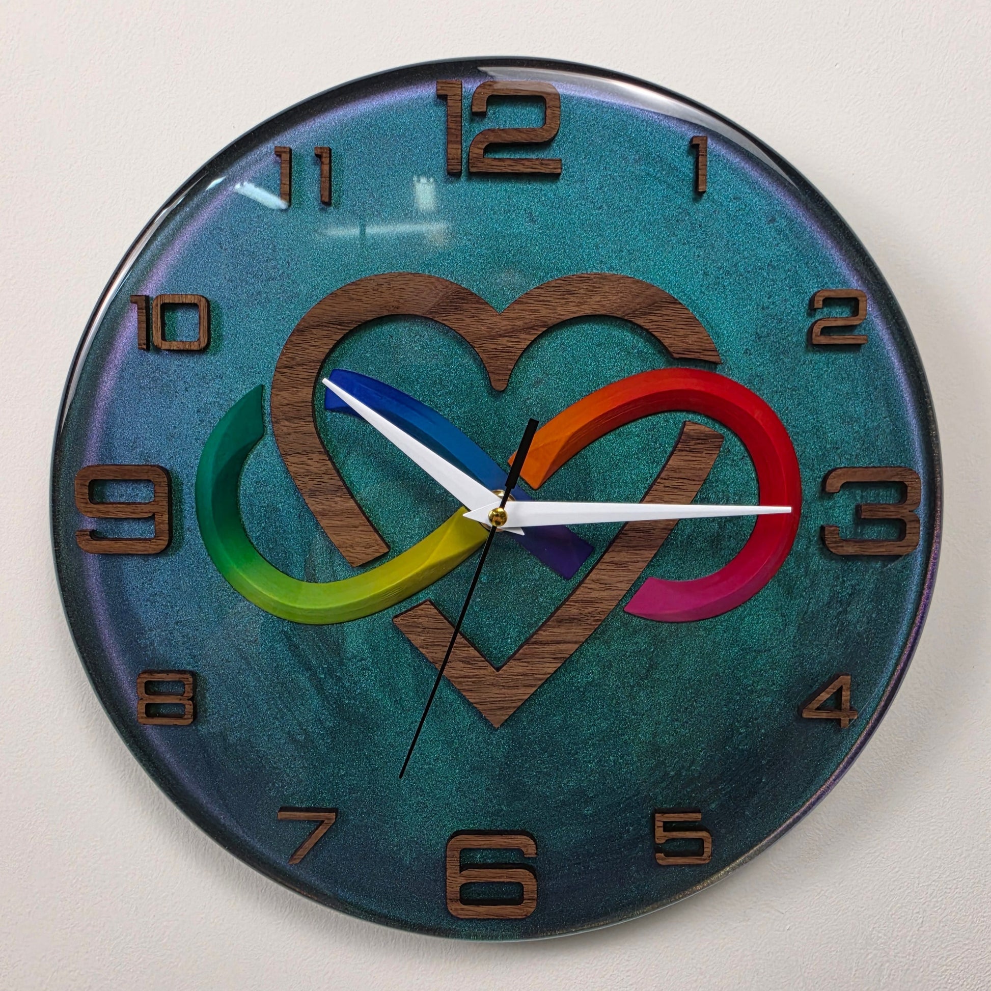 Luxury epoxy resin wall clock with colorful infinity symbol and walnut wood heart, handmade in Italy