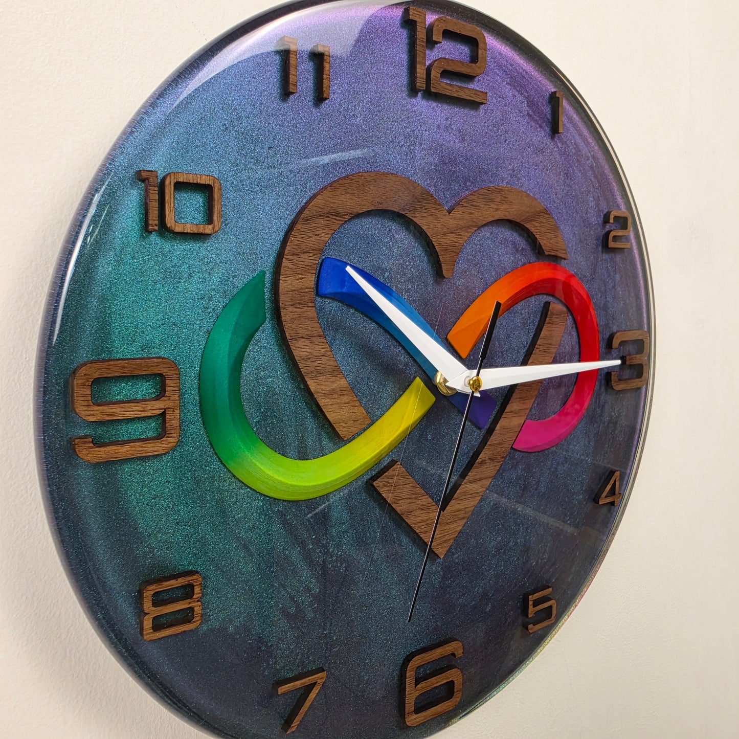 Modern handcrafted wall clock featuring infinity symbol, heart design, walnut wood and shimmering epoxy resin