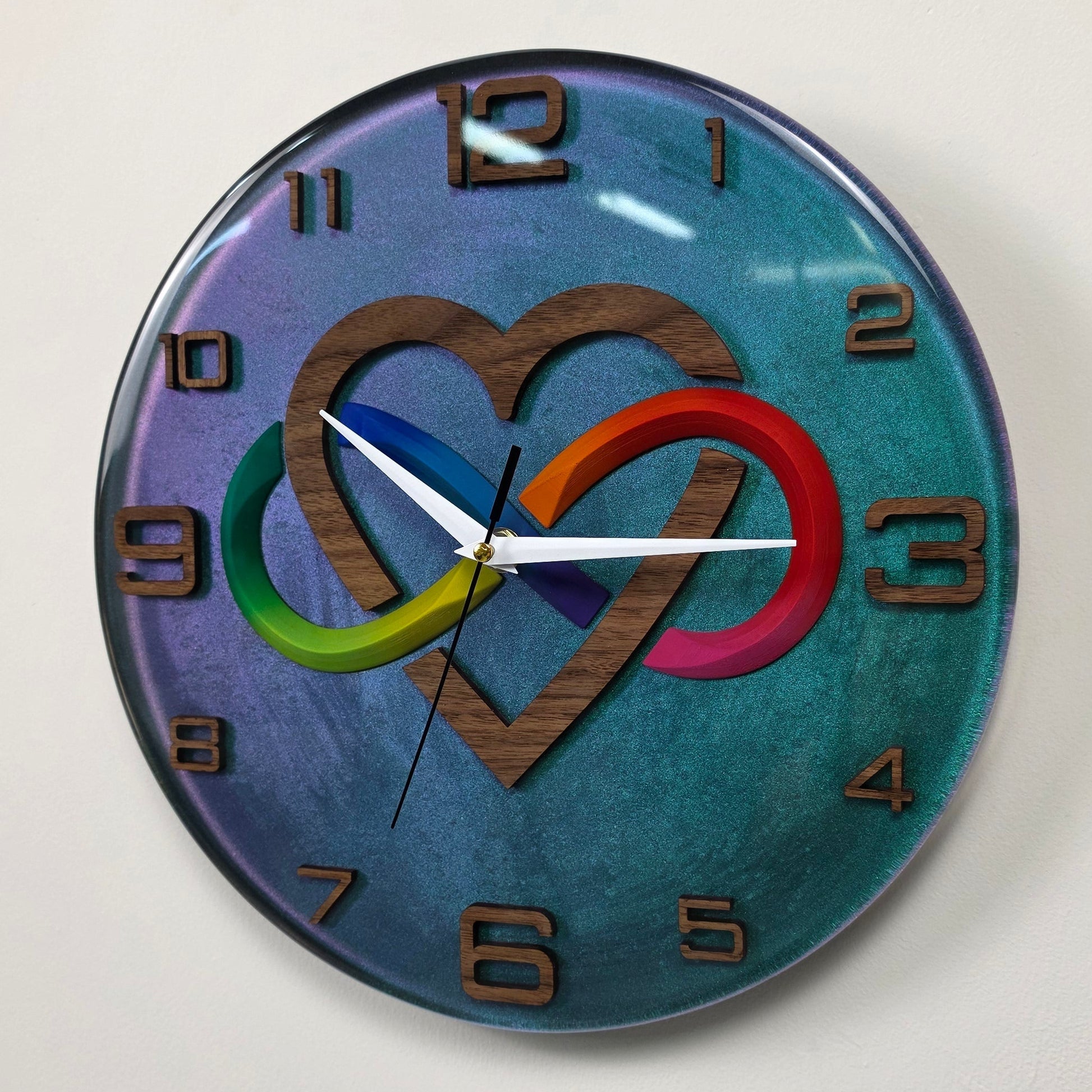 Artistic handmade wall clock from the Timeless Symbols collection, crafted from walnut wood and epoxy resin in Italy