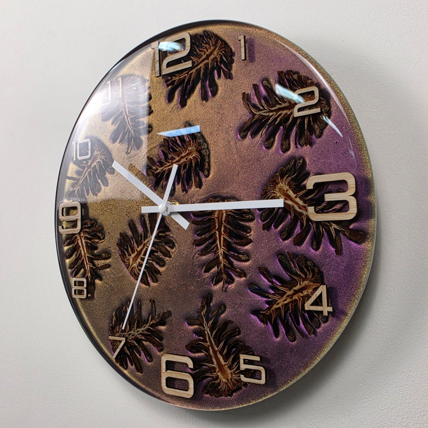 Nature-inspired wall clock featuring natural pine cones, ash wood numerals and functional art design