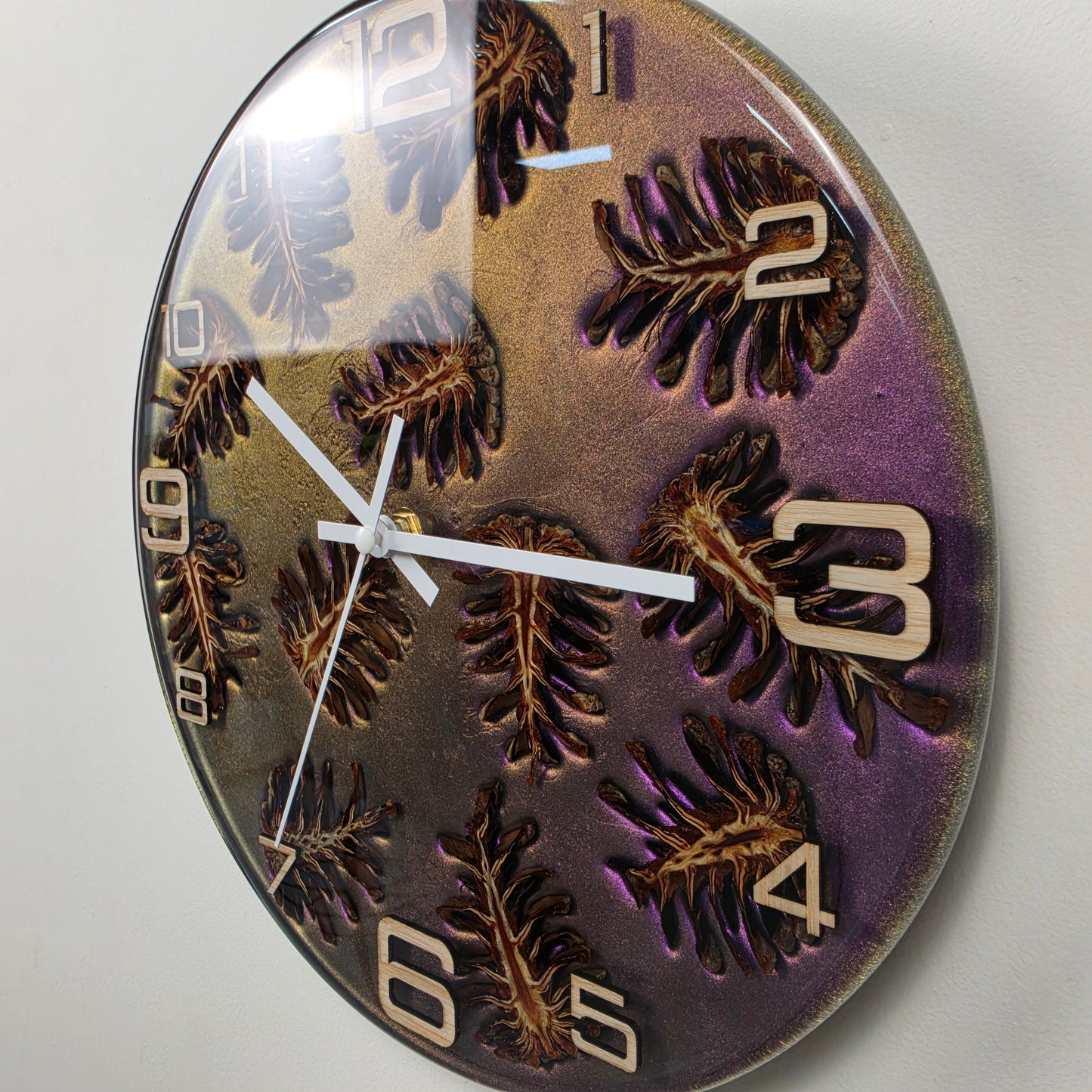 Modern epoxy resin wall clock with natural pine cones, handcrafted in Italy using premium materials