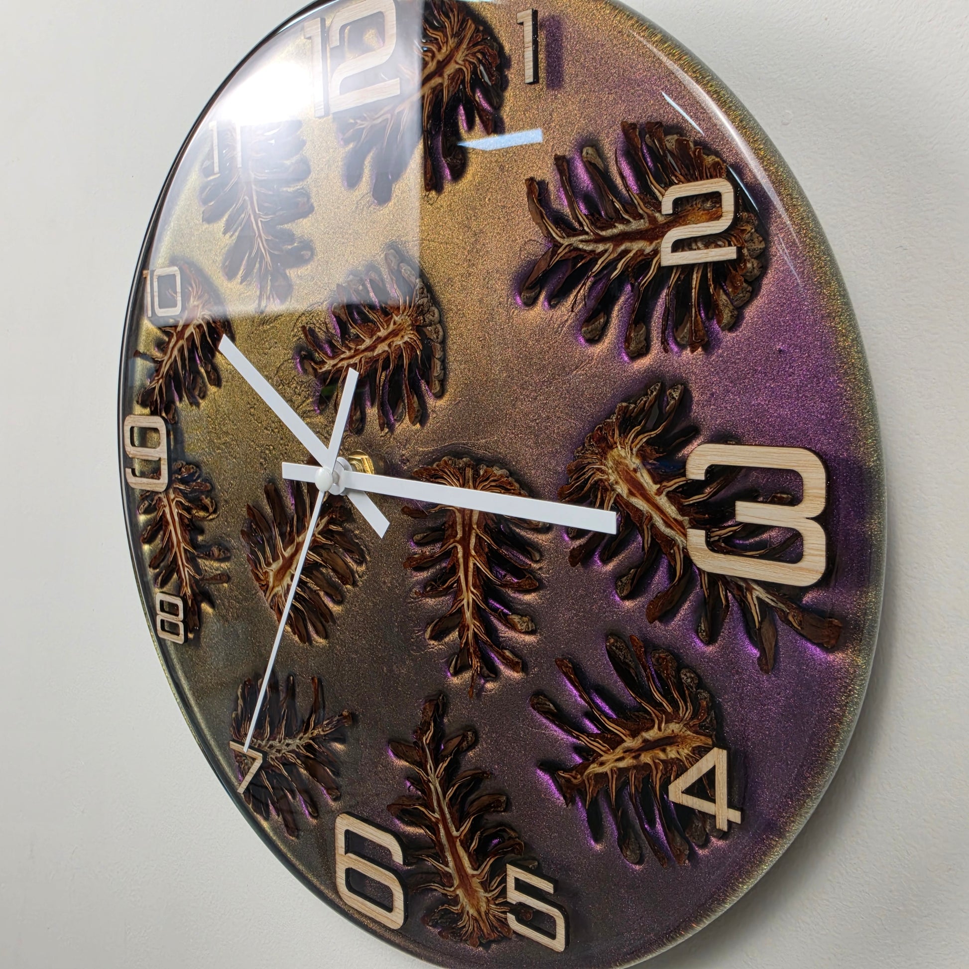 Modern epoxy resin wall clock with natural pine cones, handcrafted in Italy using premium materials