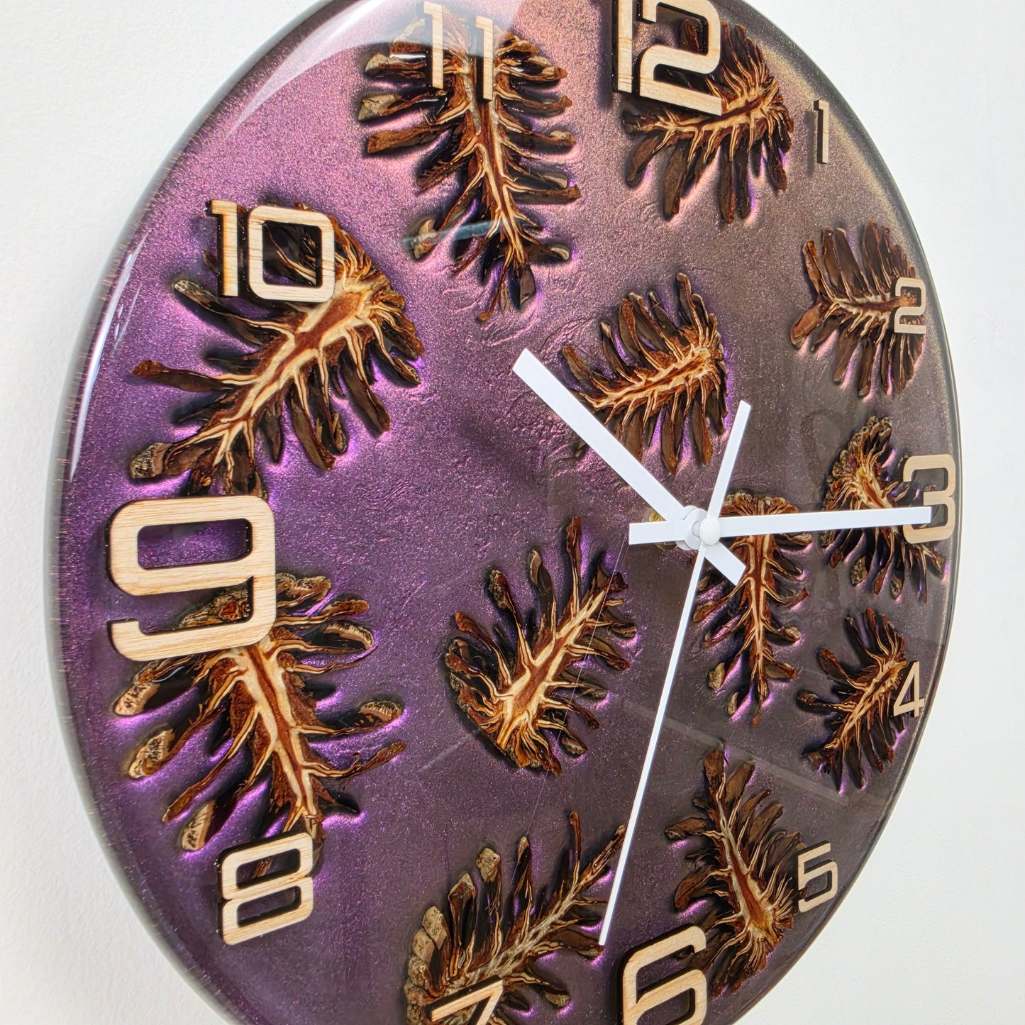 Handcrafted wall clock with real pine cones, ash wood numbers and shimmering epoxy resin made in Italy