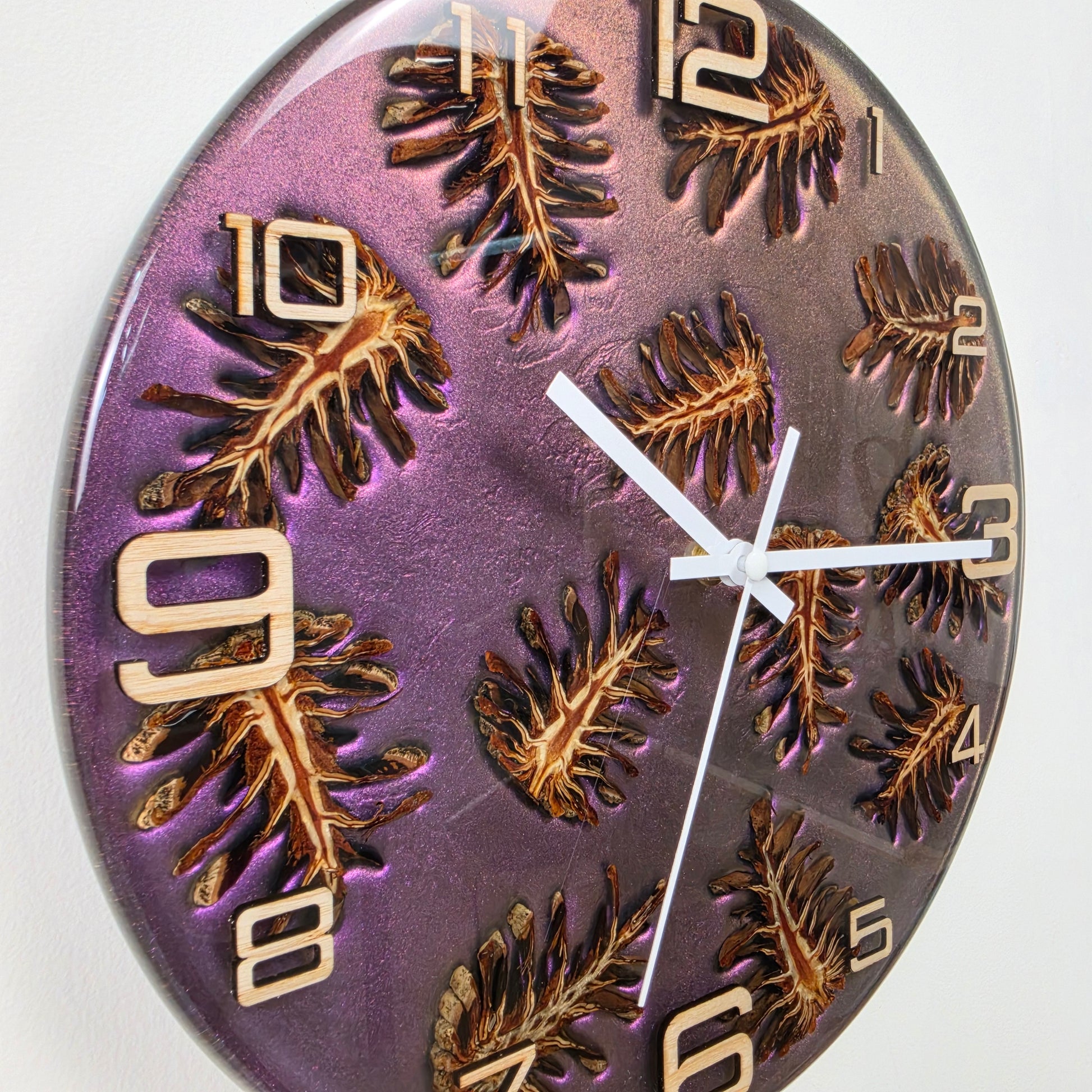 Handcrafted wall clock with real pine cones, ash wood numbers and shimmering epoxy resin made in Italy