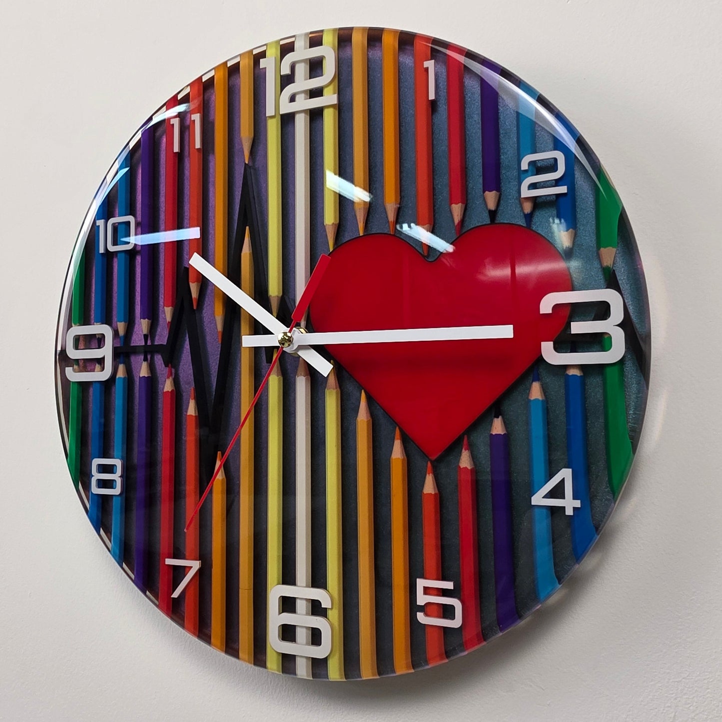Abstract Time resin wall clock combining colorful pencils, artistic symbolism, silent sweep movement, white acrylic numbers, and a handcrafted chameleon background.