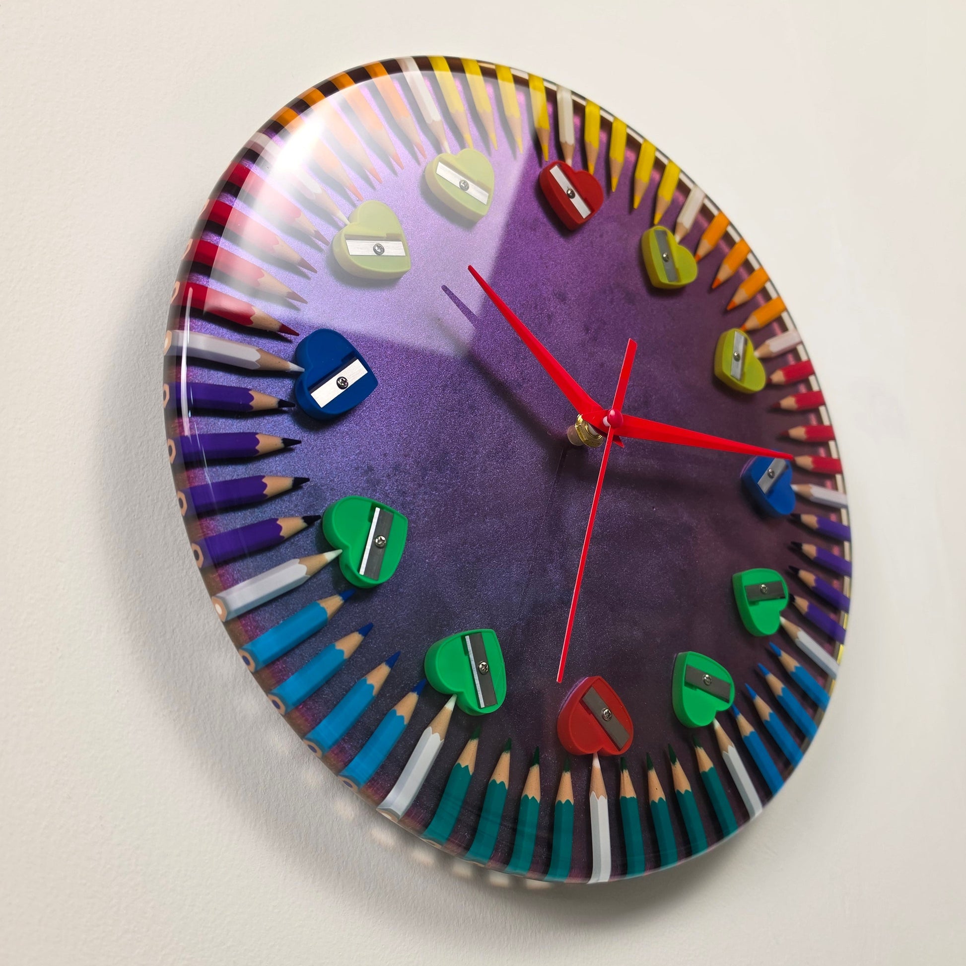 One-of-a-kind resin wall clock inspired by creativity, featuring colored pencils and heart-shaped details.