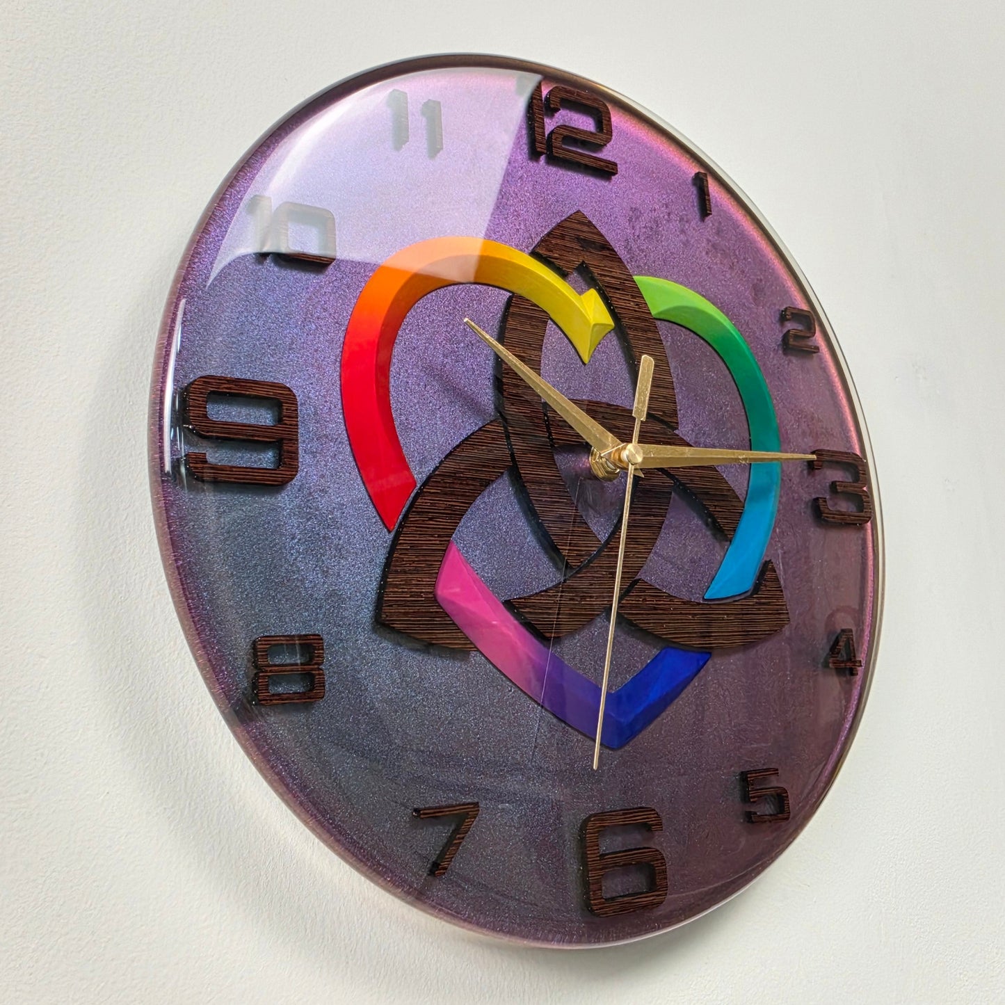 One-of-a-kind decorative resin clock featuring a Celtic-inspired Triquetra symbol, rainbow heart, chameleon background, and handcrafted wooden details.