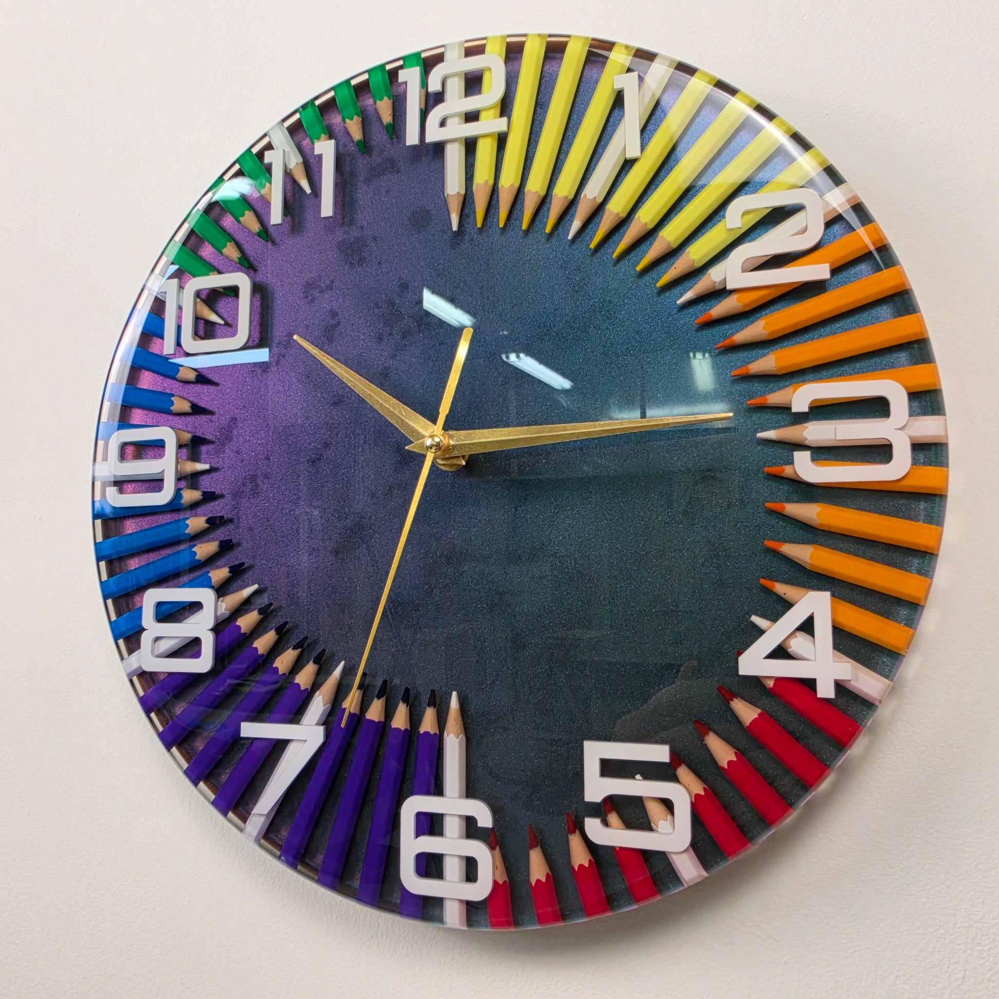 Modern resin wall clock with colorful pencils, white numbers and elegant gold hands