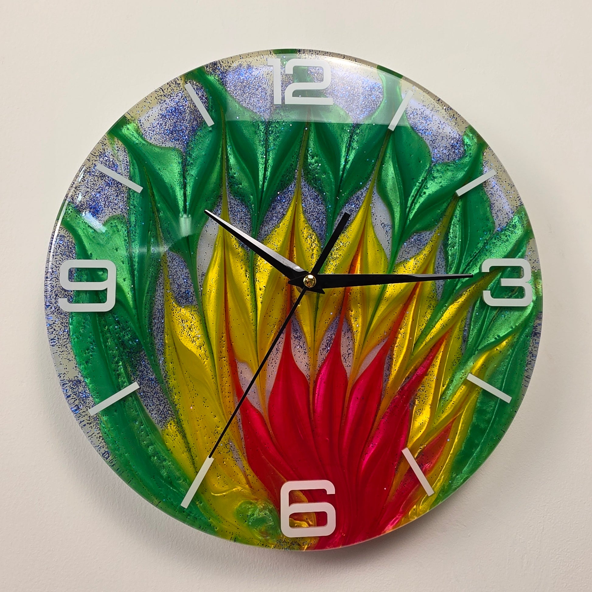 Unique handmade epoxy resin wall clock with flowing abstract colors, sparkling blue glitter, white acrylic numbers, and contemporary artistic design.