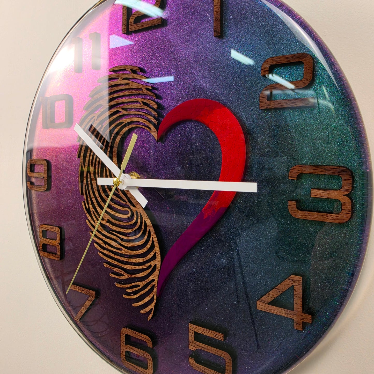 Modern resin wall clock with Black Walnut numerals, fingerprint design and vibrant chameleon pigment
