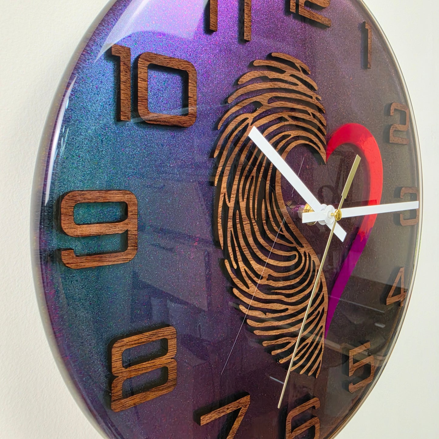 Unique artistic wall clock featuring a wooden fingerprint and heart encapsulated in clear resin